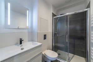 Shower, hair dryer, towels, toilet paper