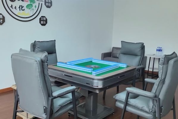 A conference room with a table, four chairs, and a small table with a water bottle.