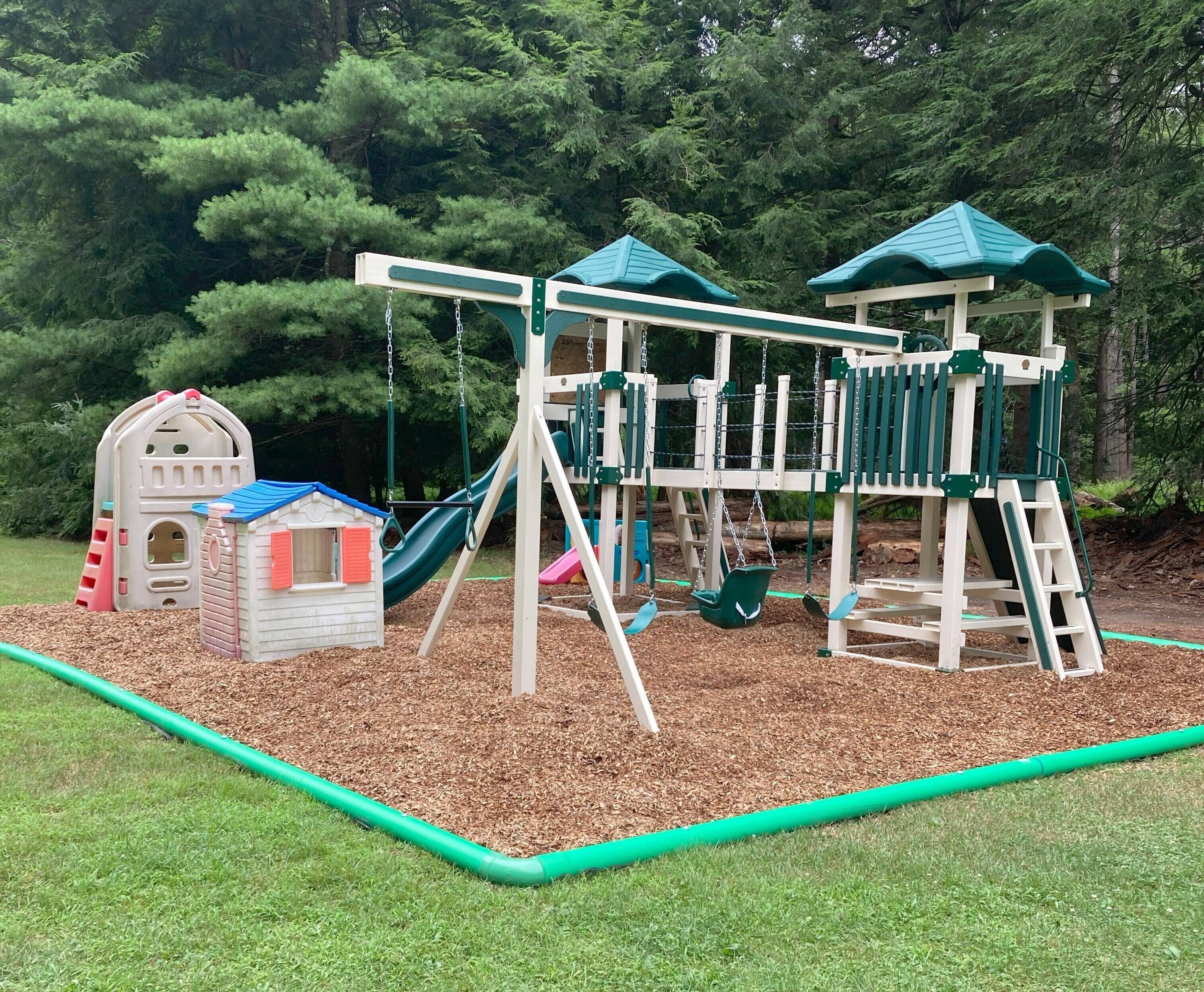 A playground with a slide, swings, and a climbing structure.