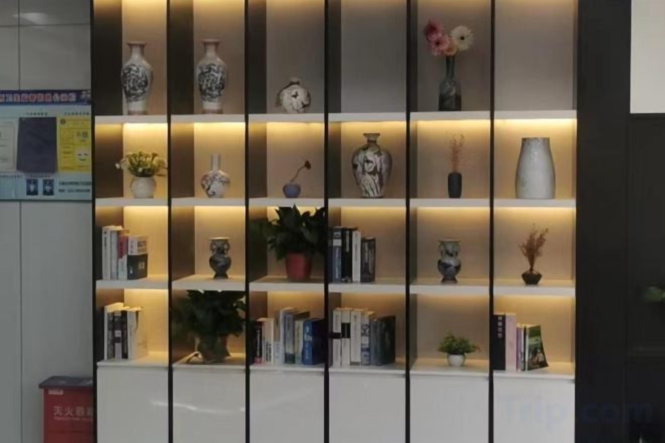 A bookshelf with decorative items and books.