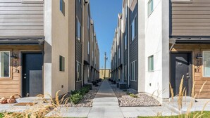 A row of modern apartment buildings with a central walkway. - Summer Getaway: Hot tub & Cold Plunge, Gear-dryer (Salt Lake City)