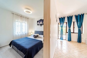 Ein Schlafzimmer mit einem Bett, einem Nachttisch und einer Wandleuchte.