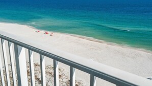 A beach with a clear view of the ocean, a white sandy shore, and a railing in the foreground. - 2 Bedroom Lighthouse w/Bunk,  3 Pools! Direct Beachfront.  Free Daily Activities (Gulf Shores)
