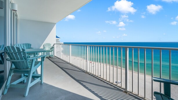 A balcony with a view of the ocean, a table, chairs, and a railing. - 2 Bedroom Lighthouse w/Bunk,  3 Pools! Direct Beachfront.  Free Daily Activities (Gulf Shores)