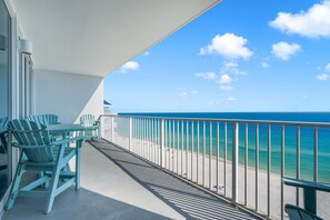 A balcony with a view of the ocean, a table, chairs, and a railing. - 2 Bedroom Lighthouse w/Bunk, 3 Pools! Direct Beachfront. Fall Specials (Gulf Shores)