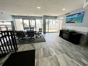 A hotel lobby with a reception desk, seating area, and a fireplace.