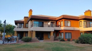 A modern two-story house with a flat roof, large windows, and a balcony. - MARRIOTT DESERT SPRINGS VILLAS 1 LOCKOUT, PALM DESERT, #1 RATED MARRIOTT RESORT (Palm Desert,)