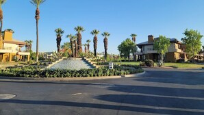 A residential area with modern houses, palm trees, and a clear sky. - MARRIOTT DESERT SPRINGS VILLAS 1 LOCKOUT, PALM DESERT, #1 RATED MARRIOTT RESORT (Palm Desert,)