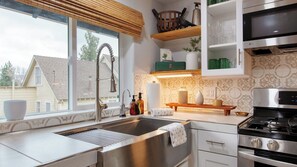 A modern kitchen with a stainless steel sink, a built-in oven, and a microwave. - Cozy 2BR Fawnskin Cabin Big Bear Lake, Hiking Trails & Snow Summit Nearby (Fawnskin)