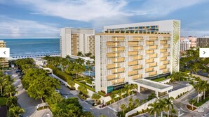 A modern hotel with multiple floors, a pool area, and a view of the ocean. - Marriott's Crystal Shores, Marco Island - 3 Bedroom (Marco Island)