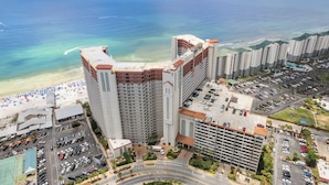 A high-rise hotel with a beach view, multiple parking lots, and a central courtyard. - Relax at Panama City Beach Balcony, Parking, Walk to Dining (Panama City Beach)