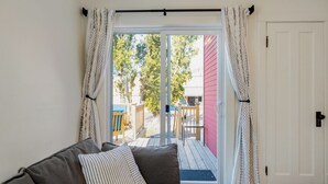 A room with a sliding glass door leading to an outdoor deck. - Charming 5-bedroom house in Cedarburg (Cedarburg)