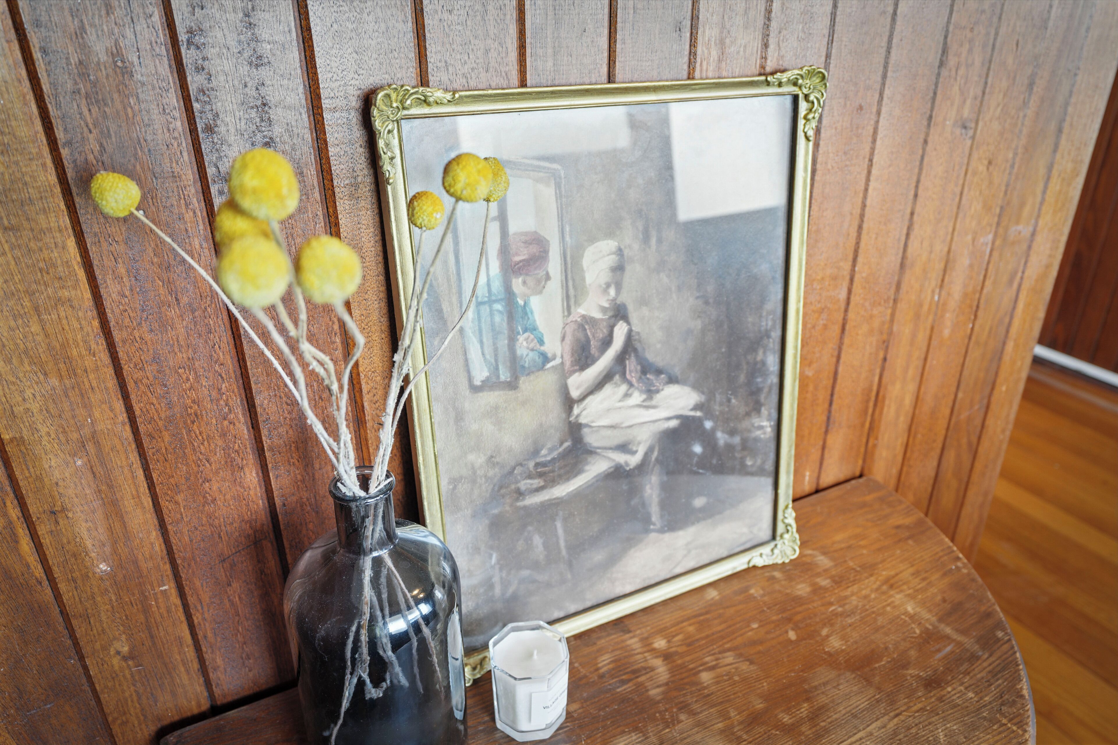 A framed photograph with a vintage appearance, placed on a wooden surface.