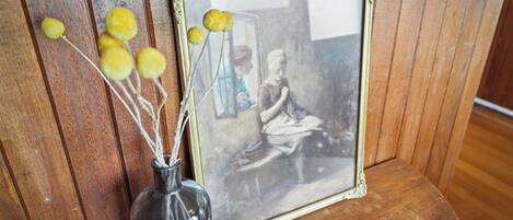A framed photograph with a vintage appearance, placed on a wooden surface.