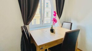 A room with a window, curtains, a table, and a chair. - 1BR Apt for 5P, 10-Min Transport to Stadthalle (Vienna)