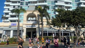 A multi-story hotel with a modern design, featuring balconies and large windows. - Aloha home-Amazing location for all GC has to offer amazing home for the family. (Labrador)
