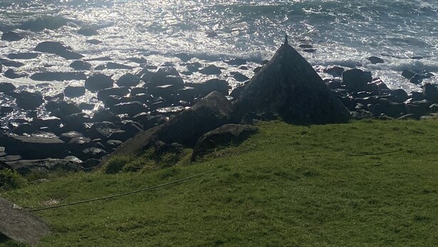 A coastal landscape with a grassy foreground, rocky outcrops, and a calm sea. - Aloha home-Amazing location for all GC has to offer amazing home for the family. (Labrador)