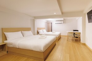 Family Room | Free minibar, in-room safe, desk, laptop workspace