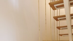 A staircase with wooden steps and ropes.