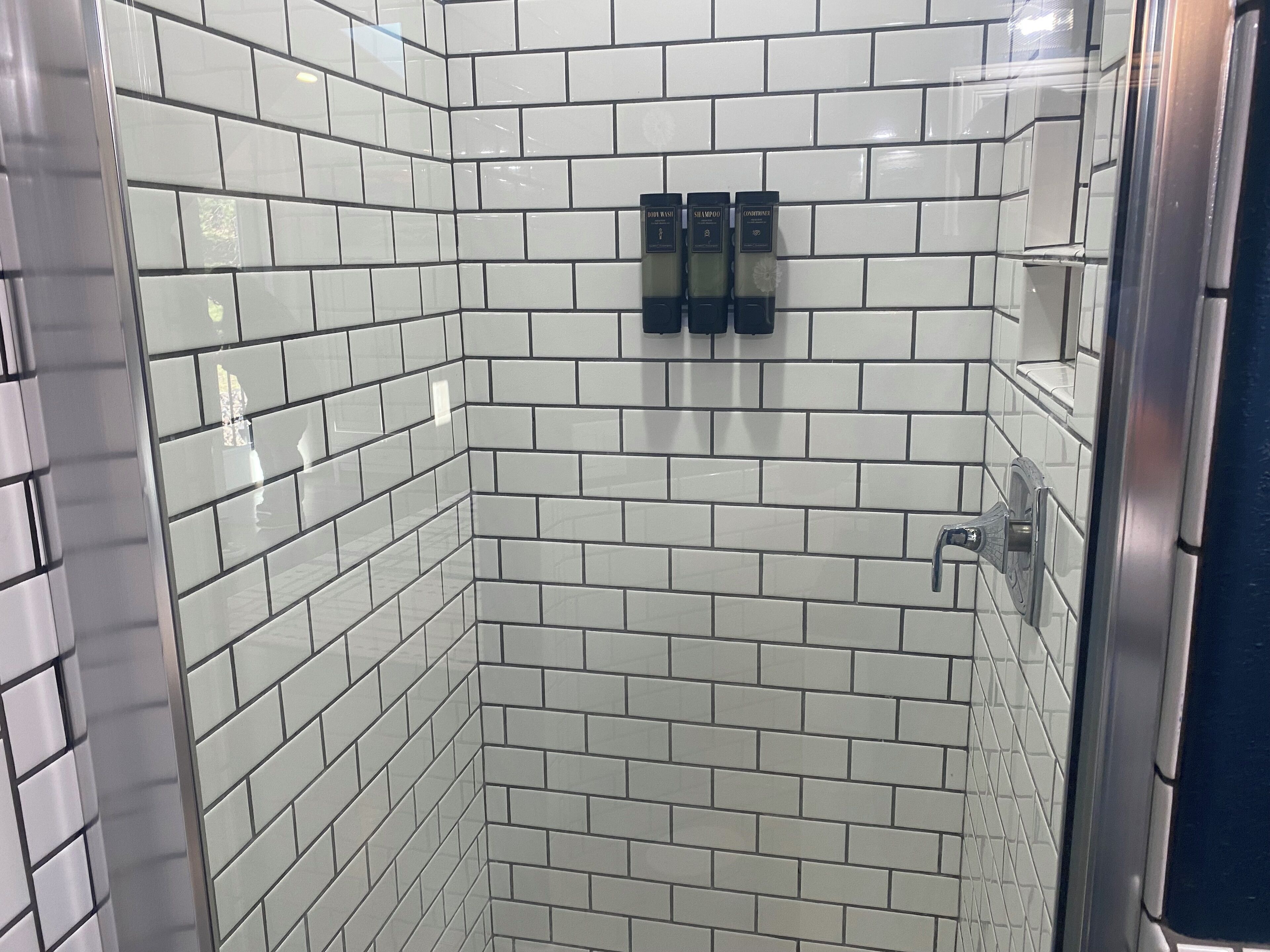 Een douche, handdoeken, zeep, shampoo