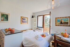 Enjoy a comfortable stay in this well-appointed room with a made bed, dining table, and kitchenette.