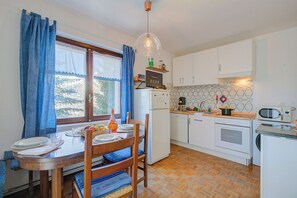 Efficient kitchen with appliances and dining area, perfect for meal preparation and dining.