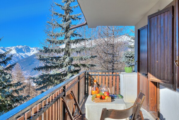 Enjoy breathtaking views of snow-capped mountains from this balcony.