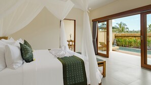 A bedroom with a bed, white and green pillows, a green patterned throw, and a canopy. - Pelana Ubud Villa (Tegallalang)