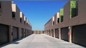 A row of parking garages with multiple levels and a central open space. - Hotel-Motel Deluxe (Tecuala)