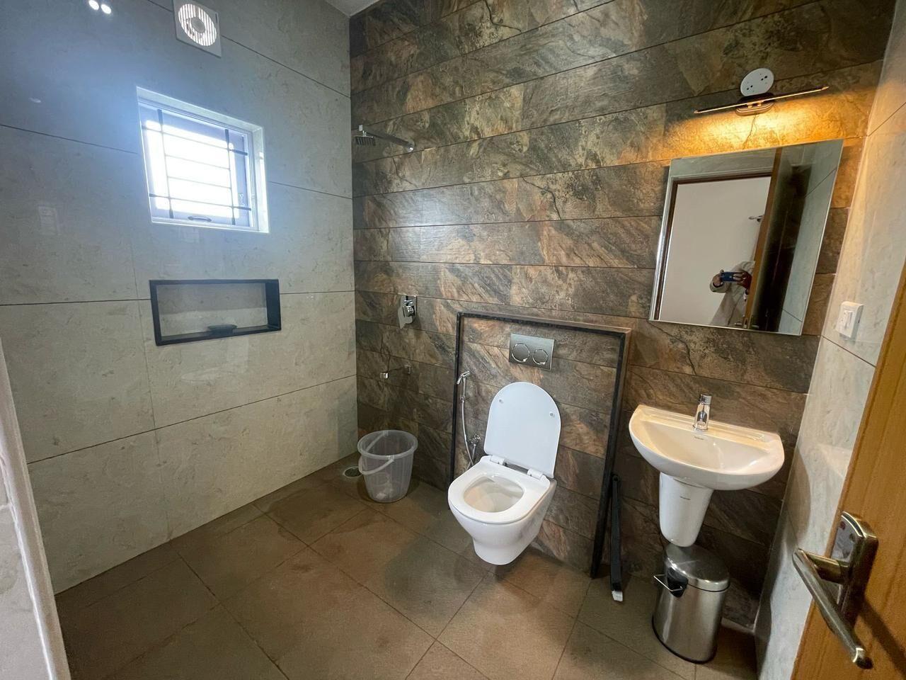 A bathroom with a toilet, sink, and shower.