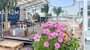 A stage with musical instruments and a banner reading "TOFIA BEACH".