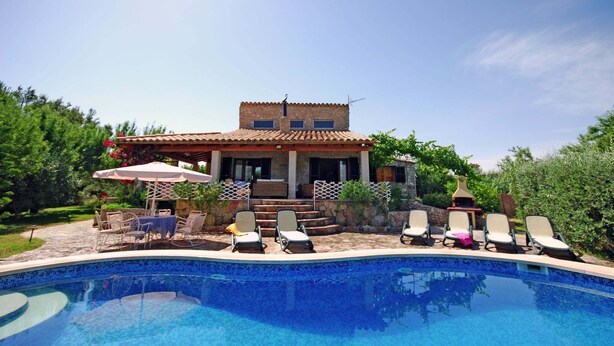 A house with a swimming pool, outdoor seating, and a garden. - Villa in Majorca near Tramuntana Mountains (Manacor de la Vall)