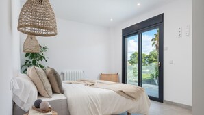 A bedroom with a bed, bedside table, and a large window. - Ca Na Cati (barcarÉs) - Villa With Private Pool (Es Barcarès (alcúdia), Illes Balears)