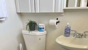 A bathroom with a toilet, a sink, a trash bin, and a toilet paper holder. - Spacious 5-Master suite house in UC Riverside with individual AC, WiFi. Enjoy! (Riverside)