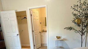 A bedroom with two beds, a small table with a lamp, and a door leading to a bathroom. - Spacious 5-Master suite house in UC Riverside with individual AC, WiFi. Enjoy! (Riverside)