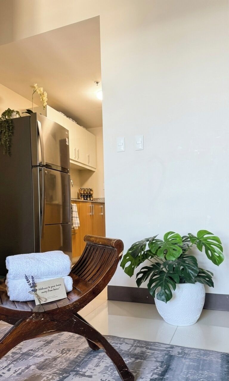 A modern kitchen with wooden cabinets and a stainless steel refrigerator.