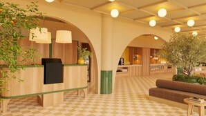 A hotel lobby with a check-in counter, seating area, and a large tree. - B&B HOTEL Sevilla Bormujos (Bormujos)