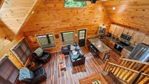 Una cabaña de madera espaciosa con sala de estar, cocina y comedor.