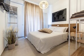 Relax in a serene bedroom with a large bed, world map artwork, and a cozy reading nook.
