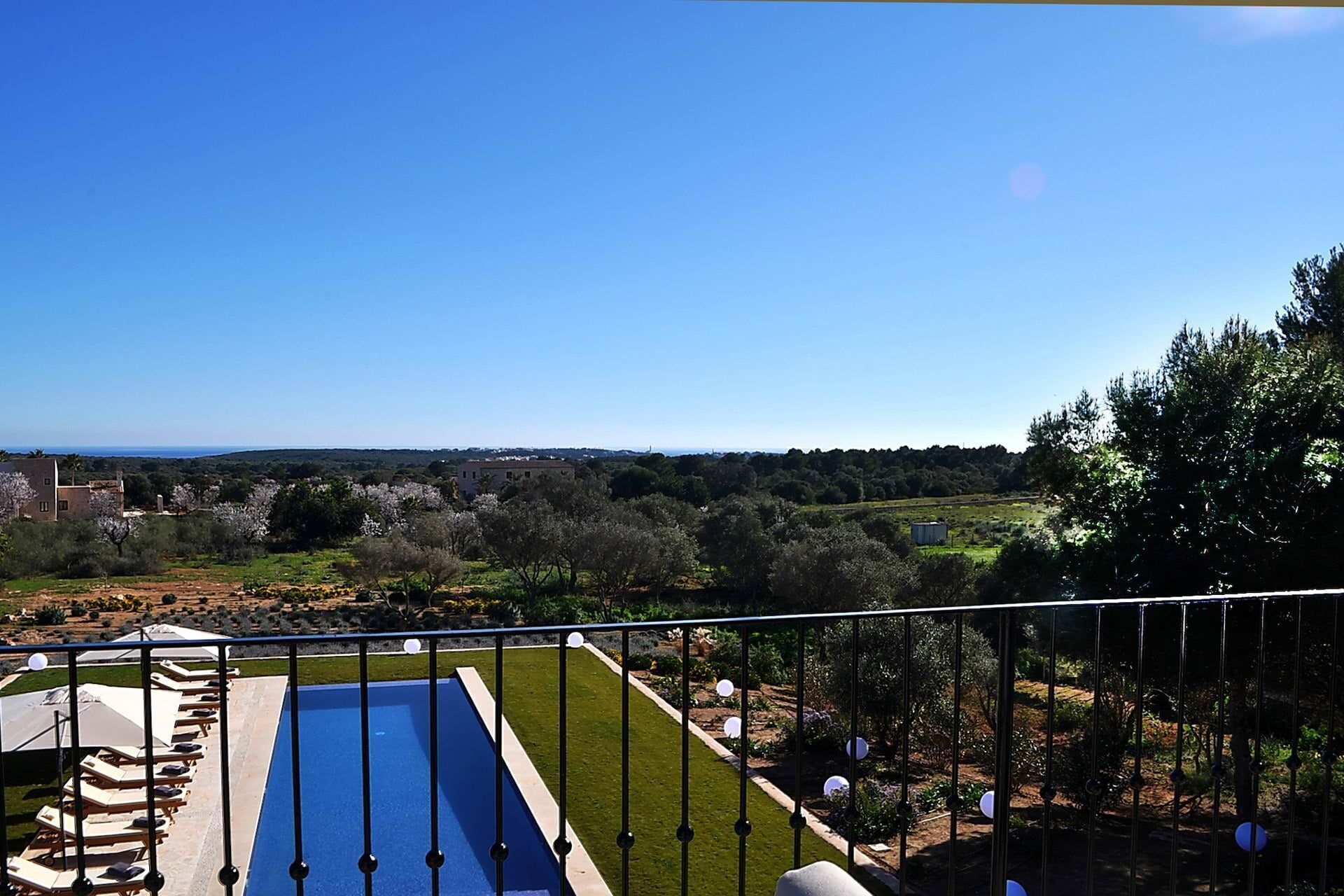 A pool area with lounge chairs and a clear view of the surrounding landscape.