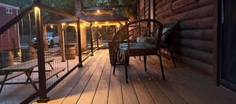 MTM Premier Funky Jungle sleeps 4 in a charming log cabin with serene lakefront views. Rustic yet comfortable, ideal for small families or groups, with access to campground amenities and seasonal activities.