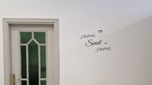 A white door with a green glass panel and a brass handle. - Isabel house (Napoli)