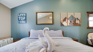 A hotel room with a bed, a mirror, a wall with a motivational quote, and a window. - Lakeview Escape with Hot Tub, lake, & Ski (Lake Harmony)
