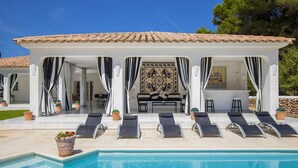 A poolside area with lounge chairs, a covered seating area, and a pool. - My Rental Homes - Villa Mosaic with private pool, gazebo and barbeque (Mercadal)