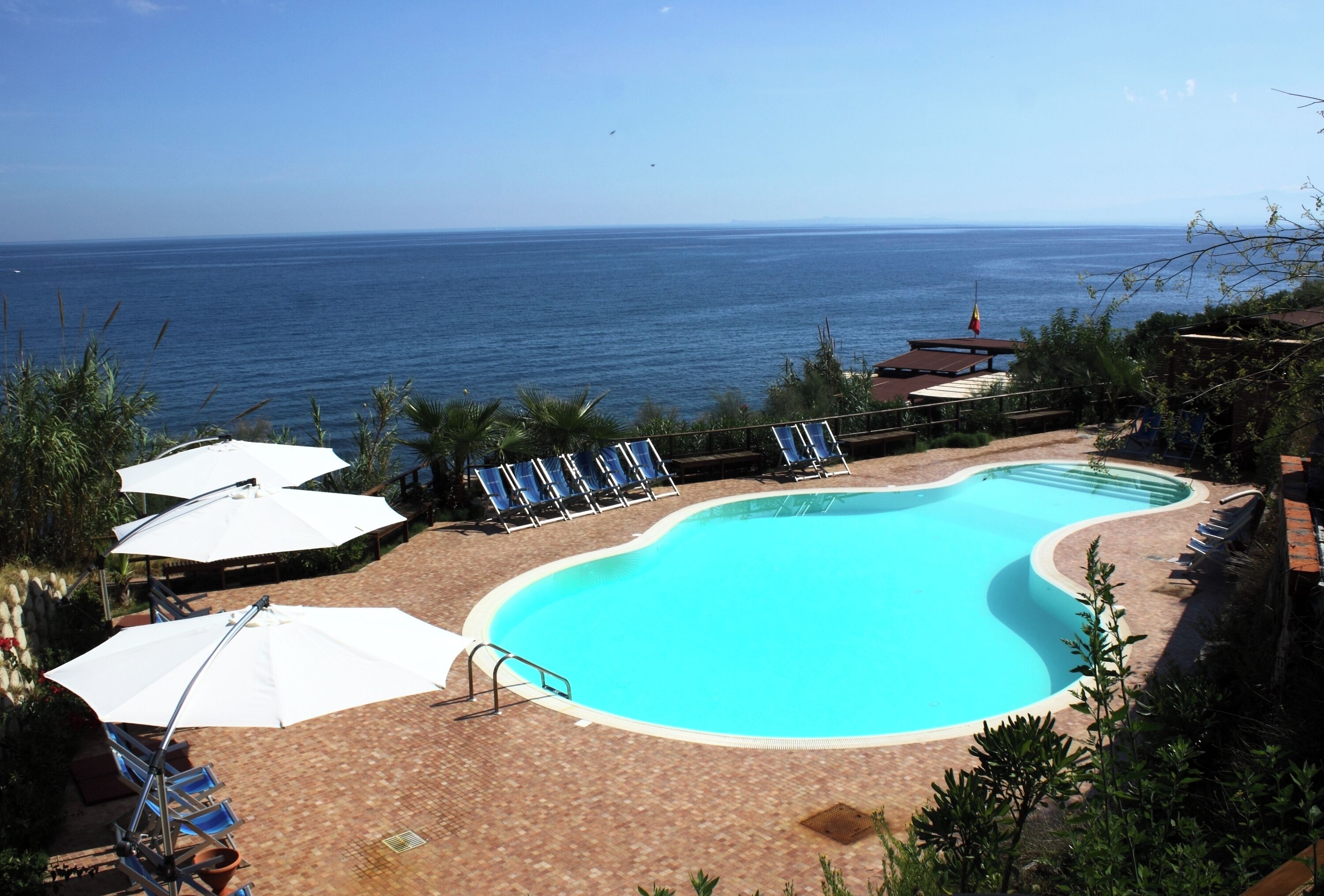 Seasonal outdoor pool, open 9:00 AM to 7:00 PM, pool umbrellas