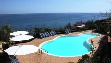 Seasonal outdoor pool, open 9:00 AM to 7:00 PM, pool umbrellas