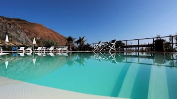 Seasonal outdoor pool, open 9:00 AM to 7:00 PM, pool umbrellas