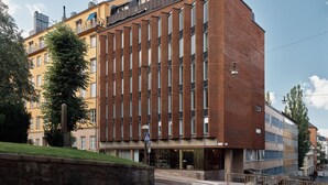 A multi-story building with a modern architectural design, featuring a mix of brick and glass facades. - Bob W Stockholm Norrmalm (Stockholm)