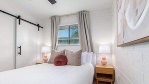 A bedroom with a bed, two bedside tables, a window with curtains, and a wall-mounted artwork. - Cheery Lynn I Cozy Luxe Escape (Scottsdale)