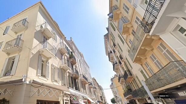 A narrow street flanked by multi-story buildings with balconies and storefronts. - Le Miroir d'André séjour bonheur au cœur de Cannes (Cannes)